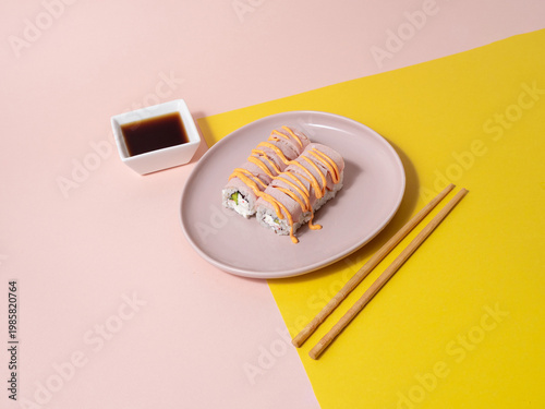 Casual dinner setting featuring salmon sushi on pink dish