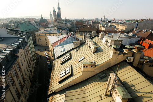 Rooftop view of Krakow old town with historic buildings and church towers under soft morning light.