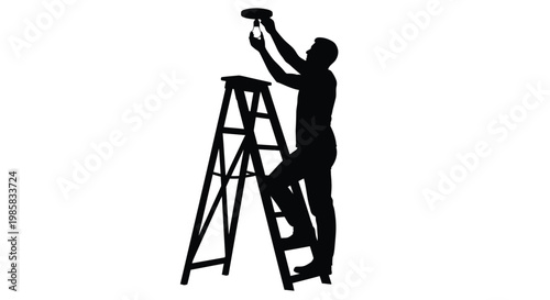Silhouette of a man on a ladder installing or repairing a ceiling light