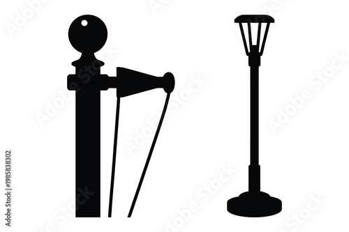 Silhouettes of a stanchion with rope and a street lamp stanchion lighting
