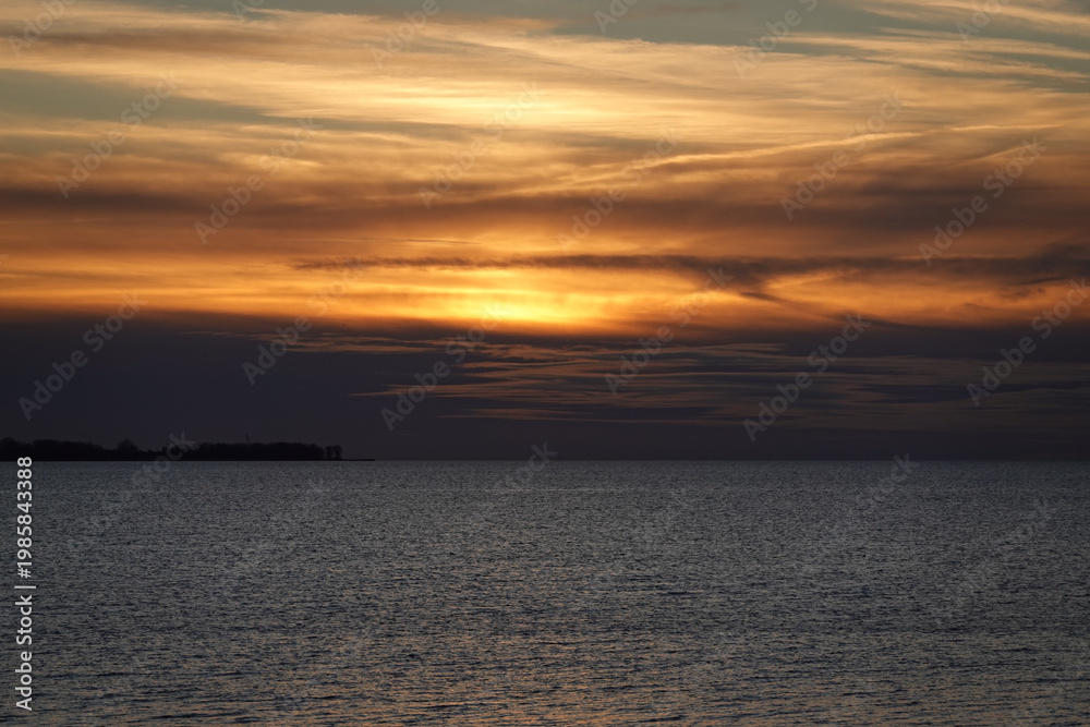 Fototapeta premium Sunset Glow Over Open Water And Distant Horizon