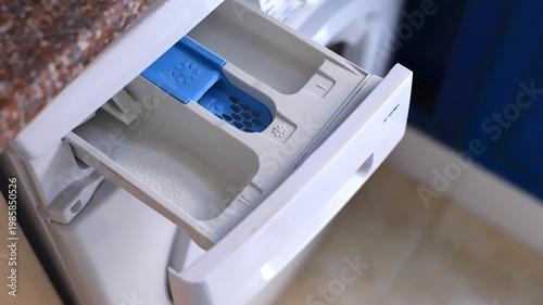 Tableau sur toile Washing machine detergent drawer with blue compartment for liquid detergent and