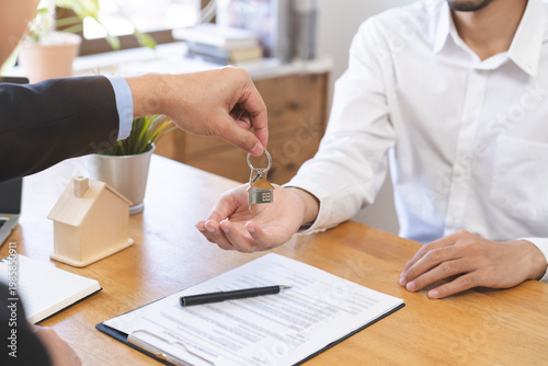 Schilderij op canvas Close up agent giving a key to new owner or tenant, client after signed signature contract rental purchase, buyer apartment, home with landlord, realtor