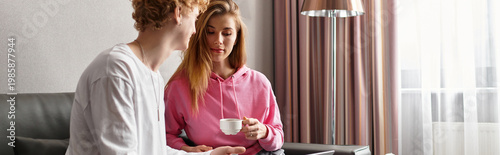 Φωτογραφία Young couple enjoys blissful moments together in a cozy hotel room while sipping