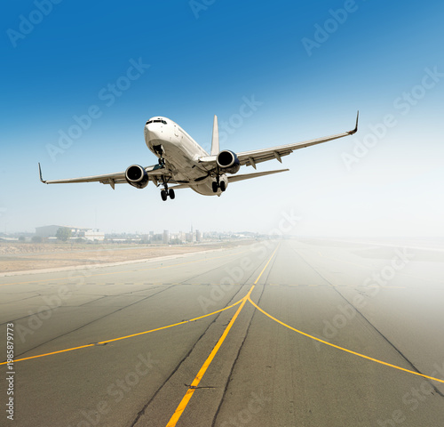 Airplane taking off from a dusty airport runway