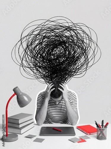 A man sits at a desk overwhelmed by a tangled mess of thoughts