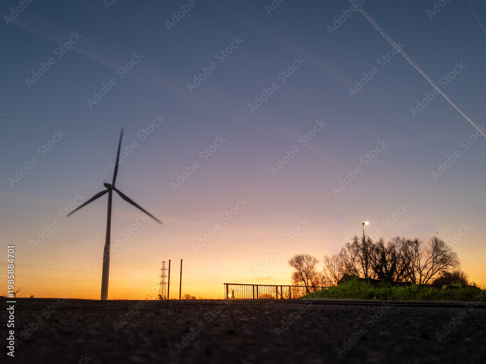 Obraz premium Wind turbine at sunset in rural landscape, Halle, België - renewable energy and sustainable power generation concept