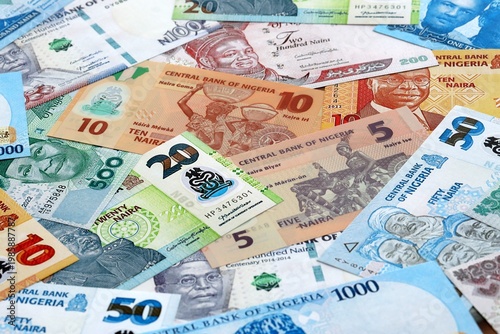 Wallpaper Mural Nigerian naira money banknotes pile on table. Nigeria bills of NGN currency close up Torontodigital.ca