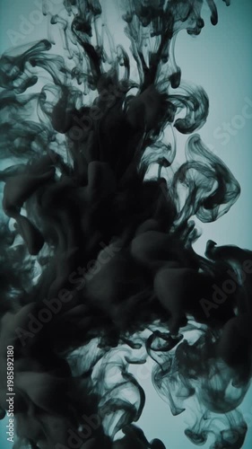 Cinematic macro of black ink swirling slowly in clear water, high contrast lighting