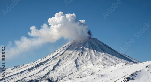 Snowy volcano erupting, plumes of smoke against a clear blue sky