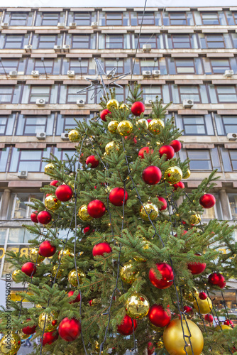 Tall Christmas Tree With Big Gold and Red Baubles Ornaments in City