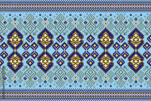 Vibrant ethnic seamless geometric pattern featuring intricate blue and gold-brown diamond and border motifs on a light blue background. Traditional tribal textile, weaving, and embroidery design.