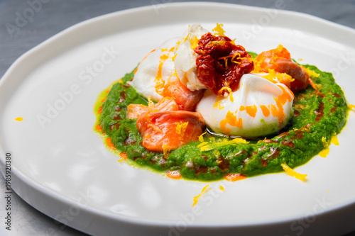 Poached eggs with salmon, spinach, and sun-dried tomatoes on a plate