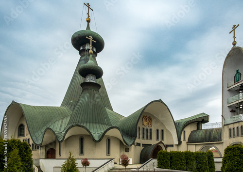Quadro su tela Two green copper onion domes with Orthodox crosses and icon mosaic, Holy Trinity