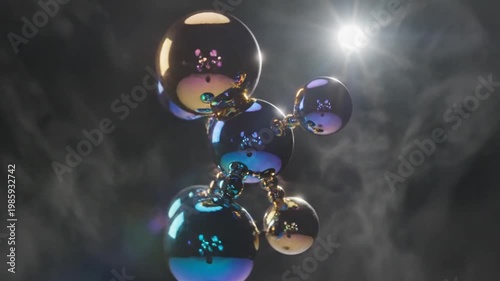 Shiny metallic spheres forming abstract structure with lens flare