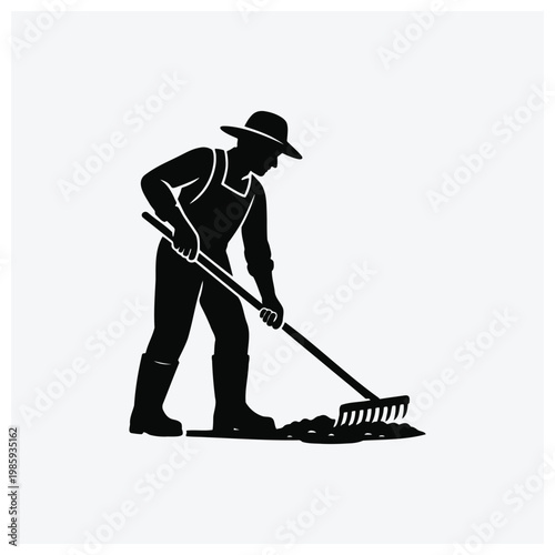 Silhouette of a gardener raking leaves or garden soil