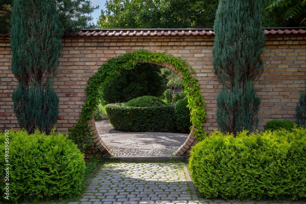 Fototapeta premium A fragment of a landscape park with lush, diverse plants.