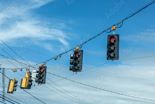 Wallpaper Mural traffic lights in black and yellow hanging at a crossing with red stop light on Torontodigital.ca