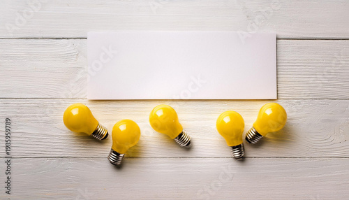 Yellow Light Bulbs with Blank Sheet – Idea, Innovation and Copy Space Concept
