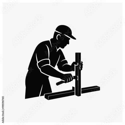 Silhouette of a carpenter working with tools on a wooden surface