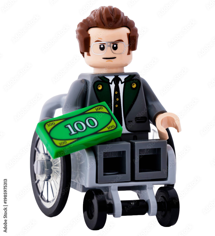 Fototapeta premium Dortmund - Deutschland 15. April 2026 - Lego Minifigur Mann im Rollstuhl mit Geld in der Hand