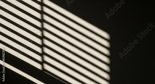 Minimalist composition showing geometric shadows and light patterns cast by window blinds on a dark wall.