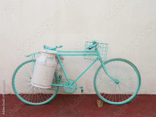 old vintage blue bicycle with milk churn