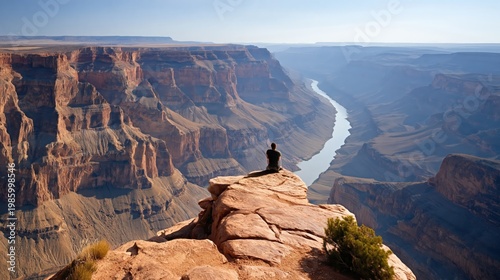 Man Sitting on Cliff Edge Overlooking the Grand Canyon and River