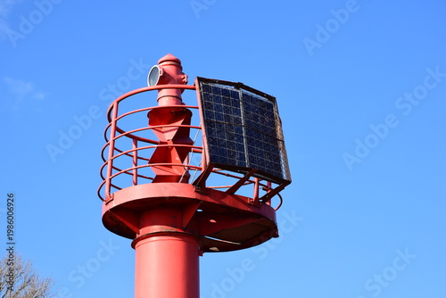 Reliable Red Navigation Aid Tower for Maritime Traffic in City Port Area