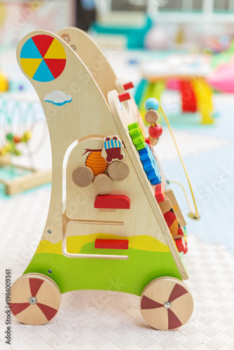 Wooden activity walker toy for toddlers in playroom