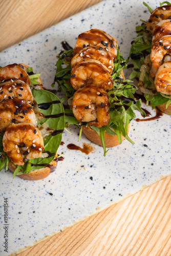 Toast with fried shrimp and salad mix. Delicious snacks with seafood