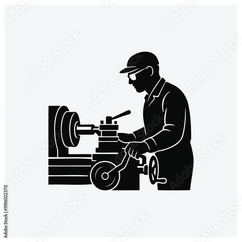 Silhouette of a machinist operating a lathe or metalworking machine