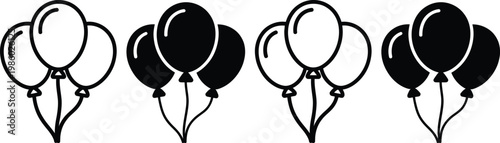 Four sets of black and white balloons tied together in pairs with strings