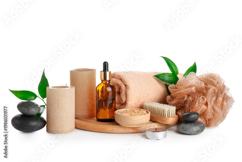 Schilderij op canvas Spa stones with candles, towel, sea salt, brush, bottle of cosmetic product and