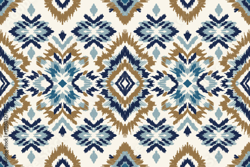 Ikat seamless pattern with geometric tribal ornament in blue and brown tones, ethnic boho textile background for fabric wallpaper and decorative surface design.