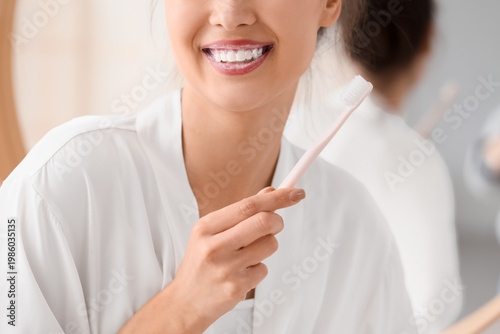 Beautiful young woman brush...