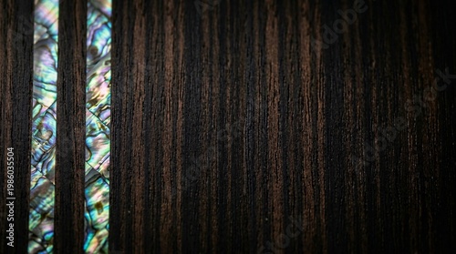 Closeup of dark macassar ebony wood texture with iridescent abalone shell inlay for premium luxury background
