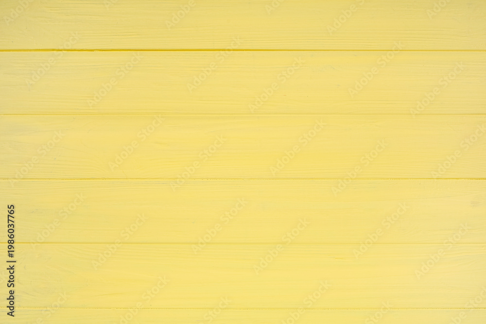 Naklejka premium Yellow painted wooden texture as background, top view
