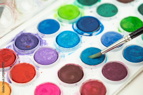 watercolor paints and brush