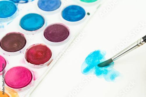 watercolor paints and brush