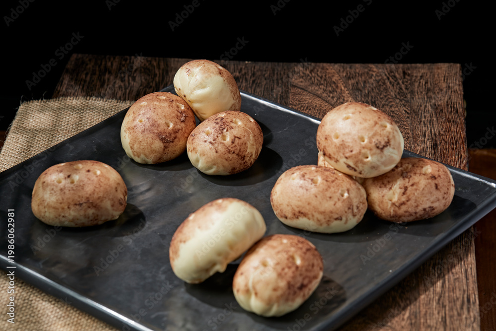 Fototapeta premium Multigrain potato buns are placed on a sushi mat.
