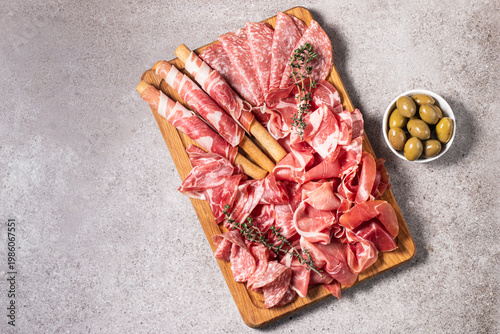 Charcuterie board. Antipasti appetizers of meat platter with salami, prosciutto crudo or jamon and olives.