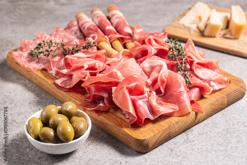 Charcuterie board. Antipasti appetizers of meat platter with salami, prosciutto crudo or jamon and olives.