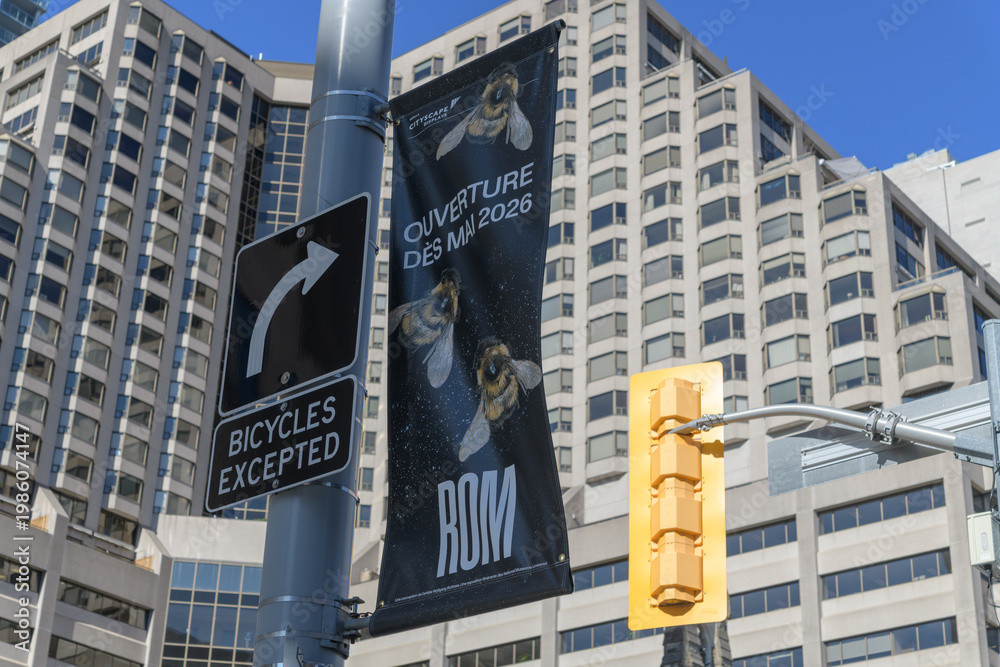 Fototapeta premium pole mounted banner advertising ROM exhibit on bees (looking northeast from Bloor St W and Queens Park), Toronto