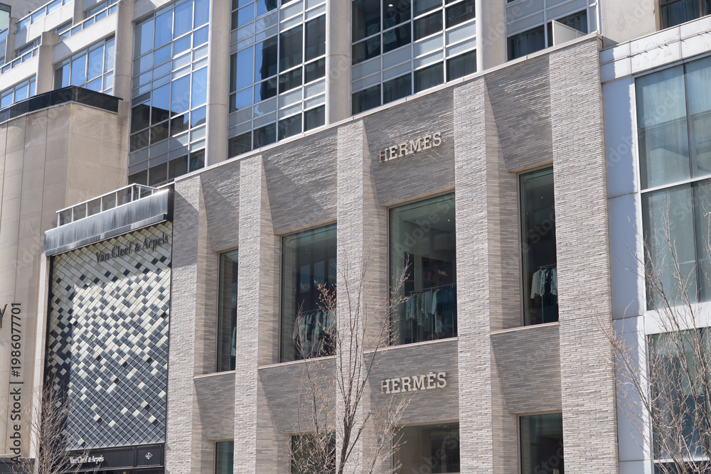 Fototapeta premium exterior building facade and sign of Hermès, a fashion accessories store, located at 100 Bloor St W, inside, 10 Bellair Condominium, Toronto