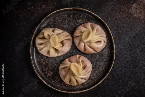 Tableau sur toile Traditional Georgian khinkali dumplings on rustic plate