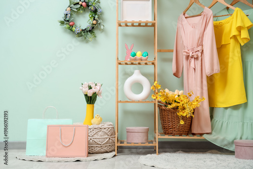 Interior of festive dressing room with beautiful flowers, shopping bags, spri...