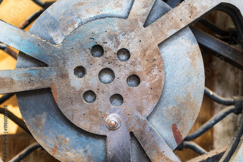 Multiple vintage metal movie film reels mounted on a decorative white lattice wall.