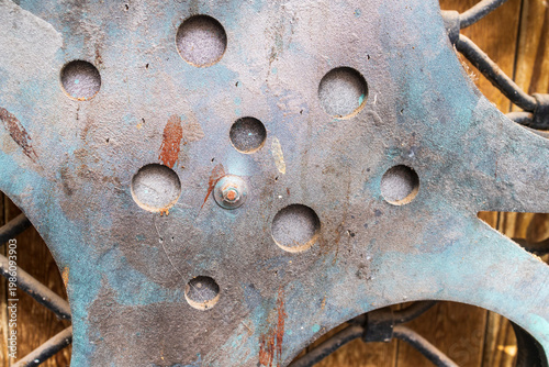 Decorative arrangement of rusty cinema film reels on a white metal grid background.