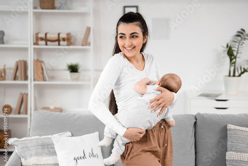 Happy young woman breastfee...